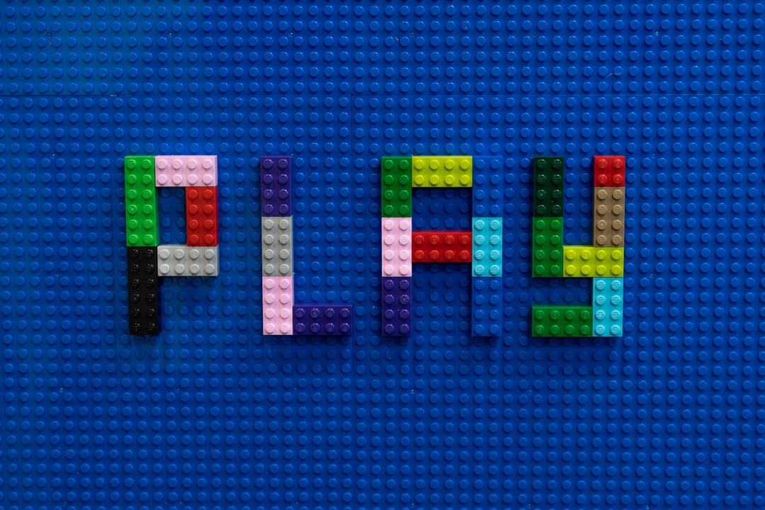 the-word-play-spelled-out-of-legos-on-a-blue-surface-1dujxpc0wfk
